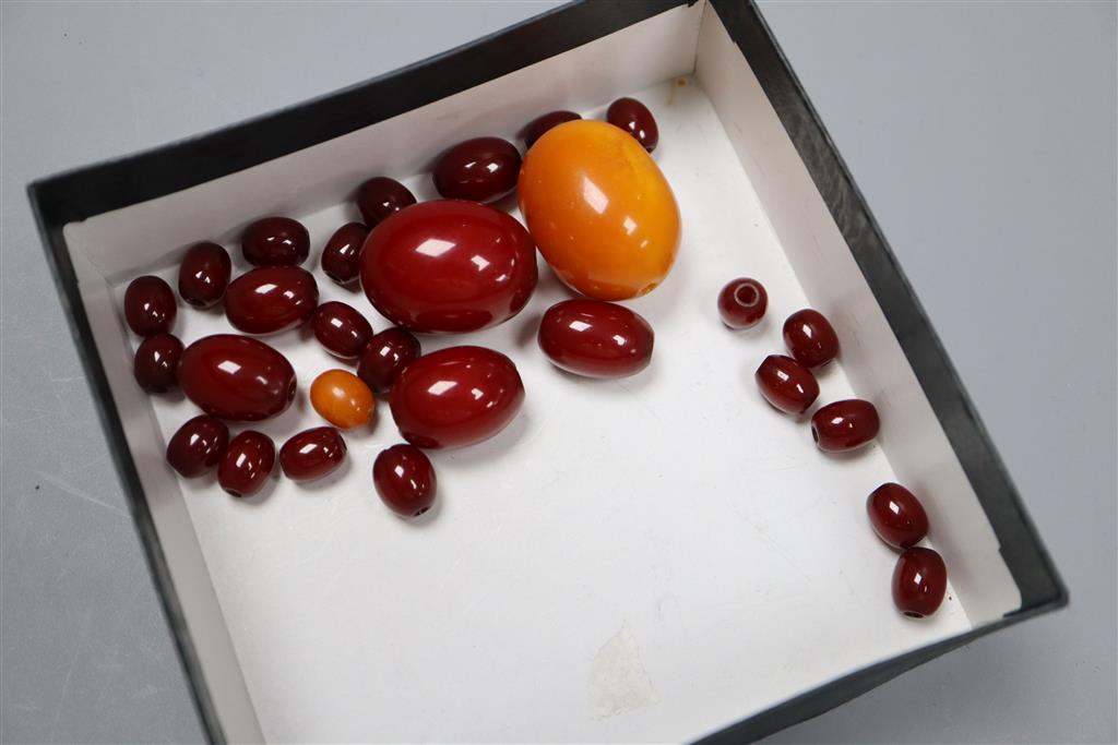 A single strand graduated amber bead necklace, 48cm, gross 40 grams, a large amber bead 10 grams and other loose beads